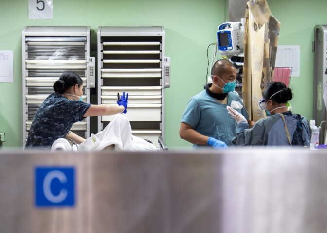 Sailors treat a patient aboard the Mercy. | Ryan Breeden/US Navy