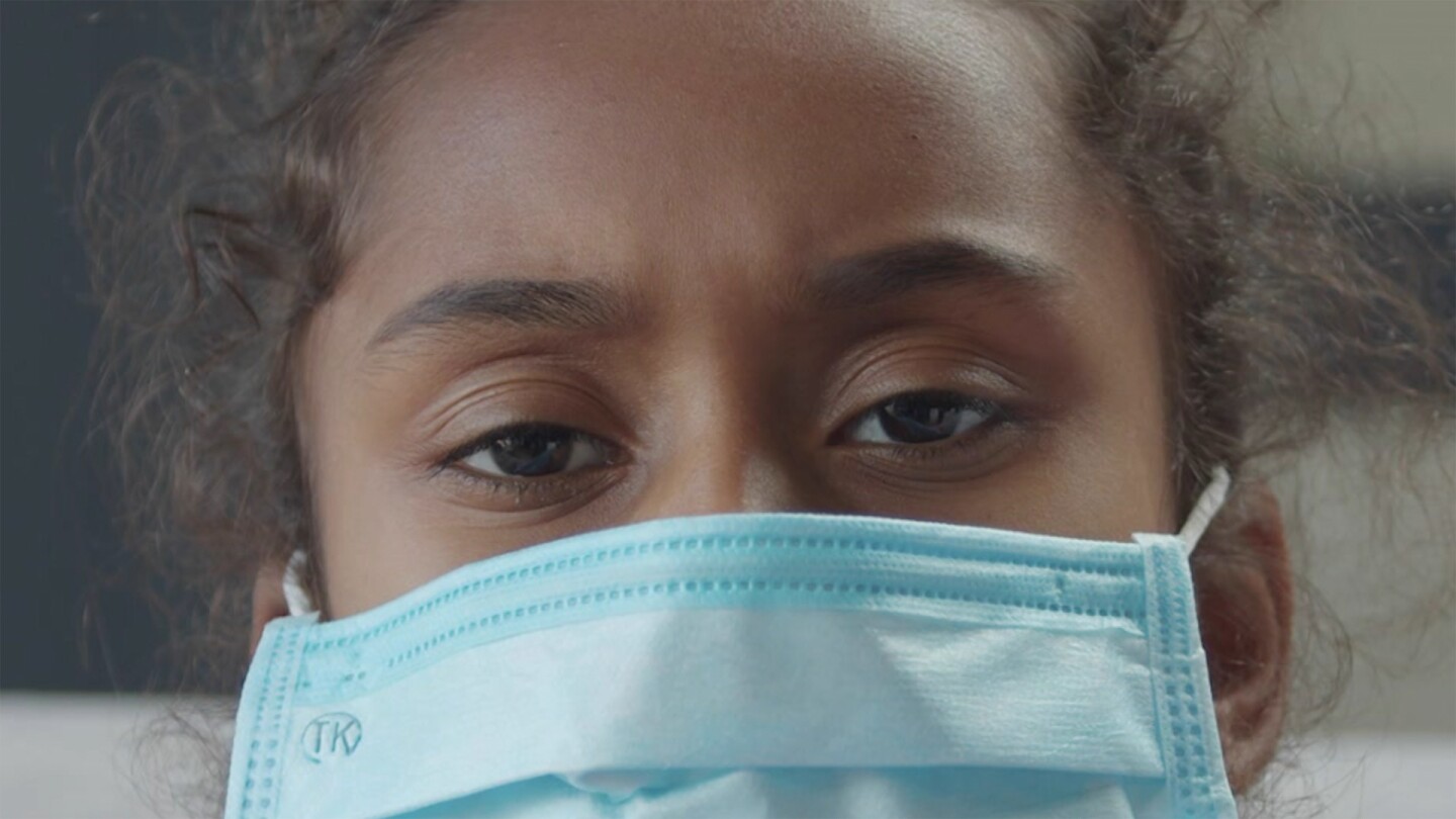 Closeup of a person wearing a mouth-covering mask.