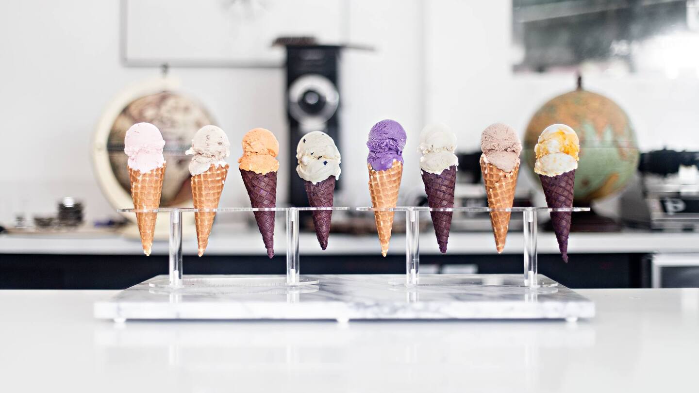 A row of ice creams in cones.