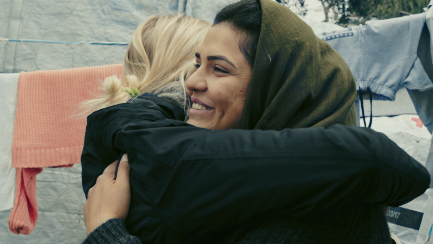 Linnea Engstrom and Raihana Hakimzada embrace in Moria camp.