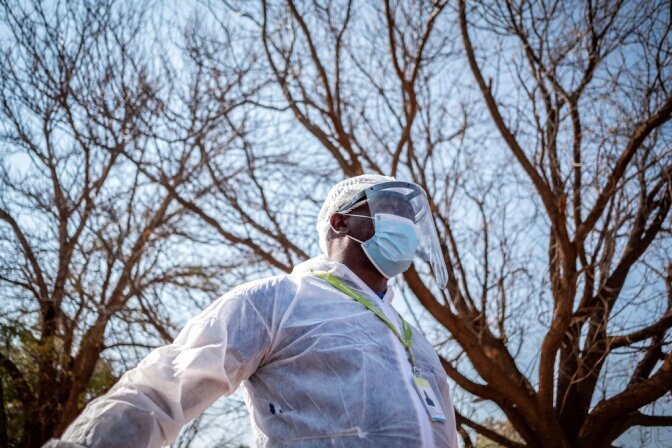 A Phlebotomist with the National Health Laboratory Service is pictured outside the Pudumong Healthcare Centre in the North West Province, South Africa, during a routine visit on September 4, 2020. | Thomson Reuters Foundation/Gulshan Khan
