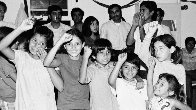 CSRC_LaRaza_B11F13C3_RR_023 Children at a musical performance by Estudiantina de la Facultad de Ingenieria from UNAM | Raul Ruiz, La Raza photograph collection. Courtesy of UCLA Chicano Studies Research Center