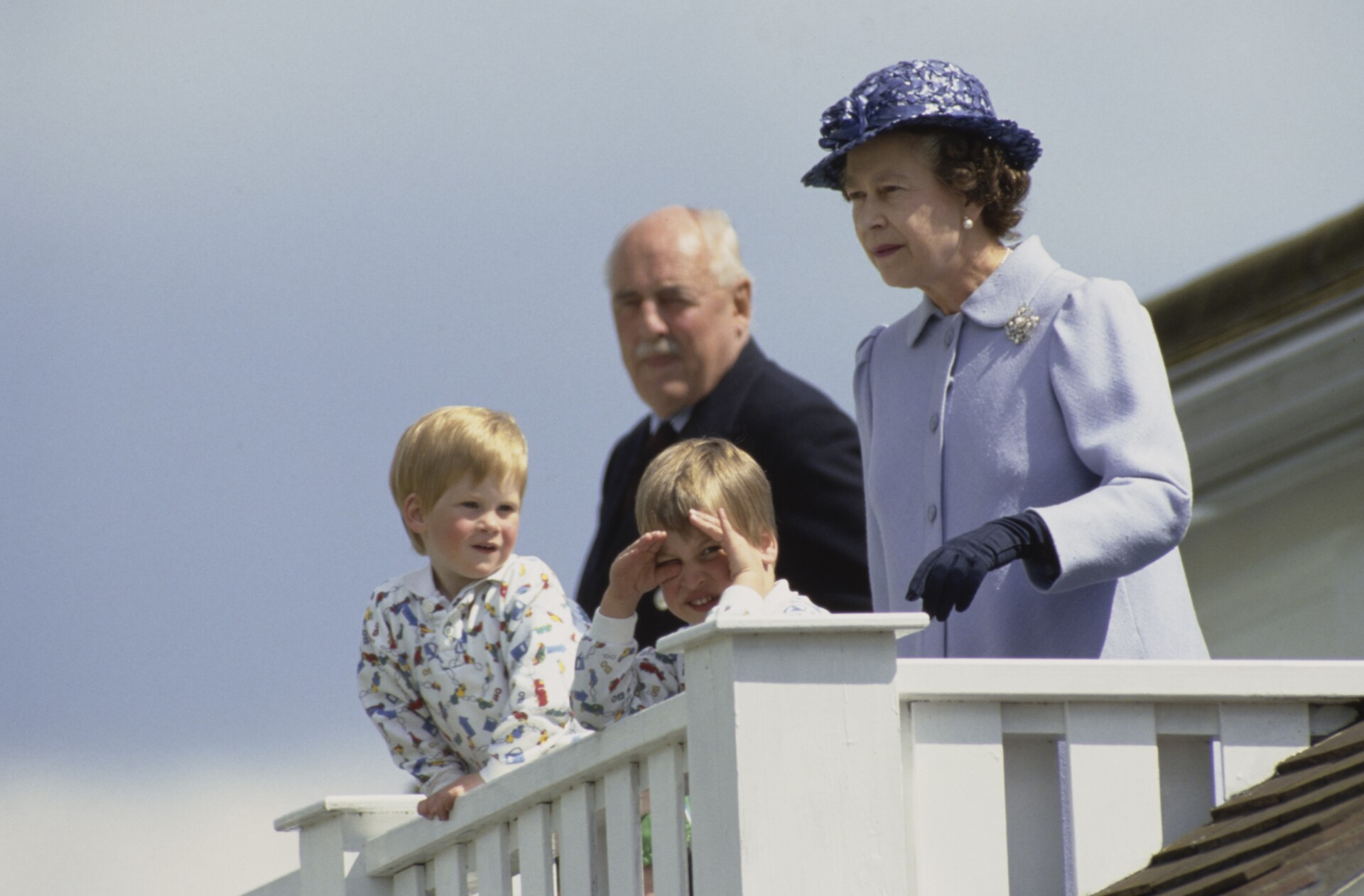 Prince Harry, Prince William, and Queen Elizabeth II stand in the Royal Box at the Guards Polo Club at Smiths Lawn, in Windsor Great Park, Windsor, Berkshire, England, 14th June 1987.