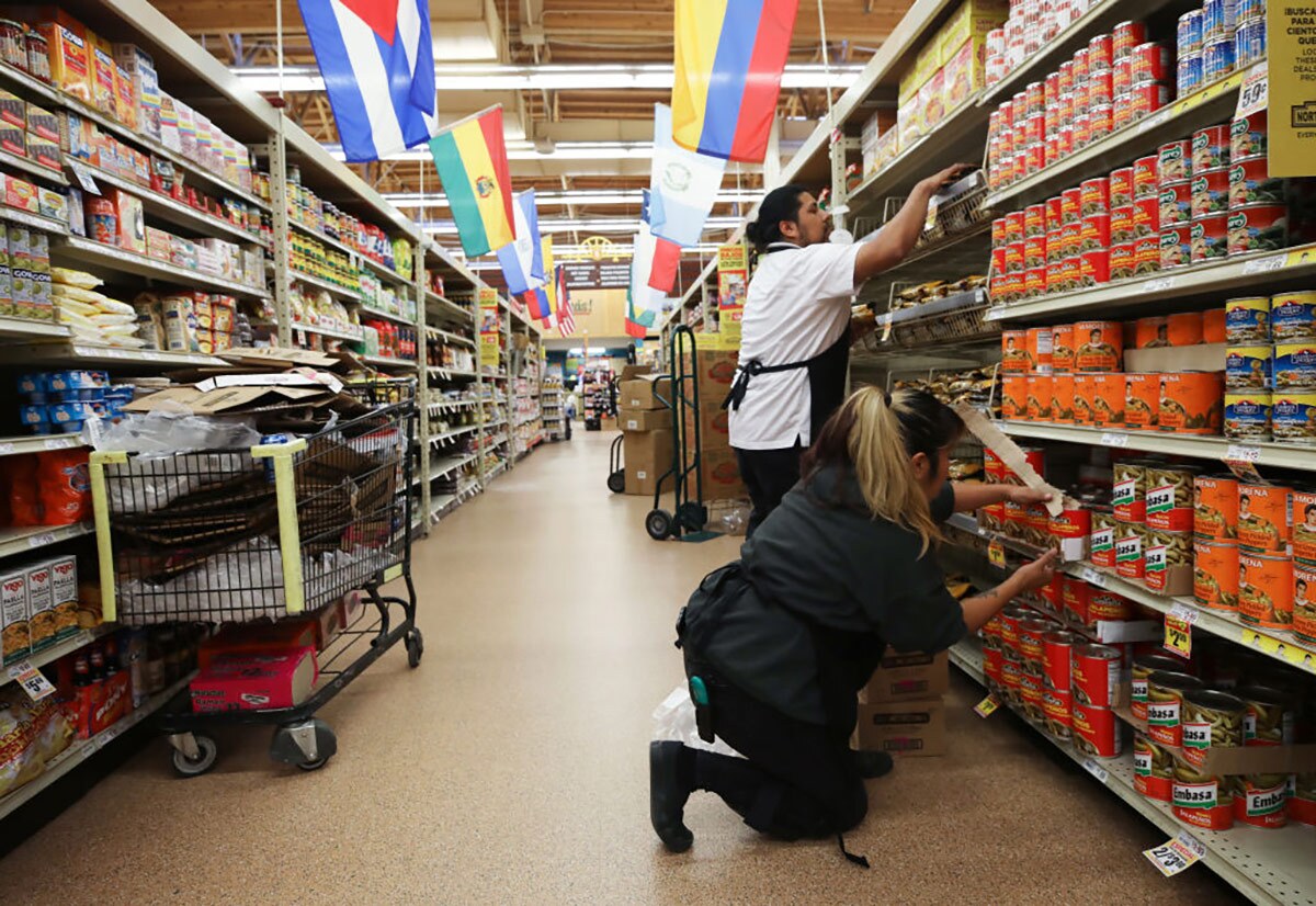 Workers re-stock items during special hours open only to seniors and the disabled at Northgate Gonzalez Market, a Hispanic specialty supermarket, on March 19, 2020 in Los Angeles, California.