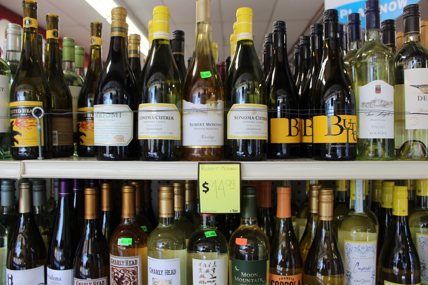 Close up on wine bottles in liquor store | Karen Foshay