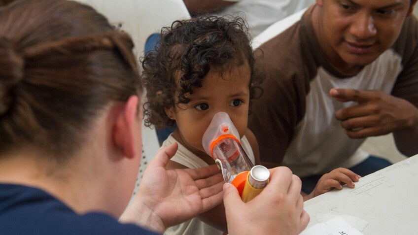 Child learns to use inhaler | Public Domain Photo