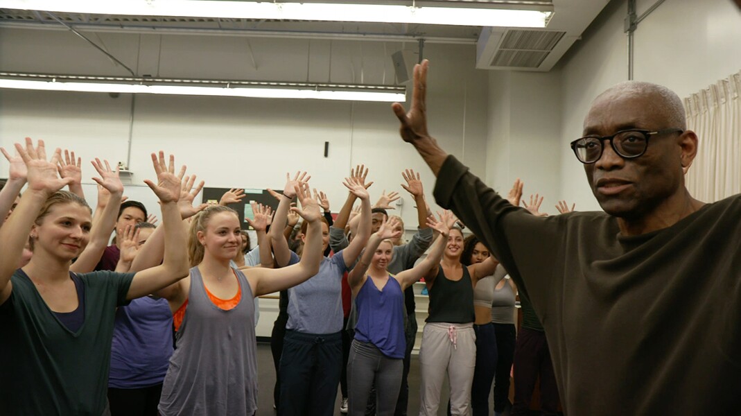 Bill T. Jones in rehearsal with Loyola Marymount University (LMU) students with arms raised in 2016. | Courtesy of Rosalynde LeBlanc