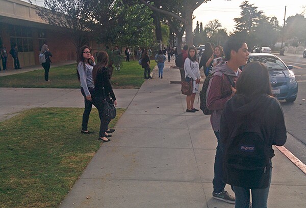 Students wait to get picked up in front of Mountain View High School