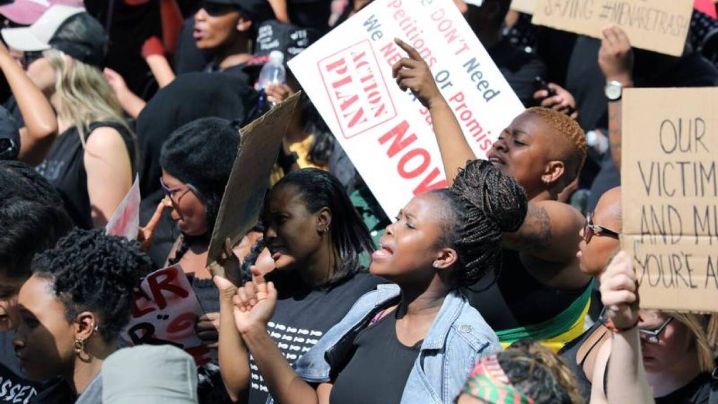 FILE PHOTO: Women hold placards as they protest against gender-based violence, outside the Johannesburg Stock Exchange in Sandton, Johannesburg, South Africa, September 13, 2019. | REUTERS/Marius Bosch