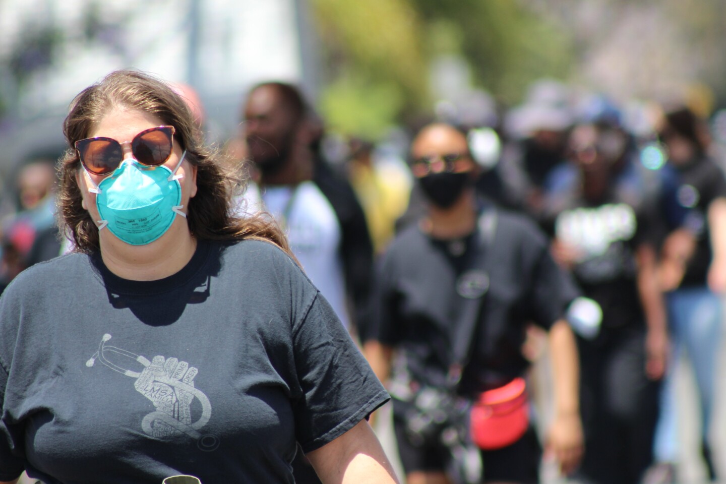 Woman wearing a face mask, walking | Karen Foshay