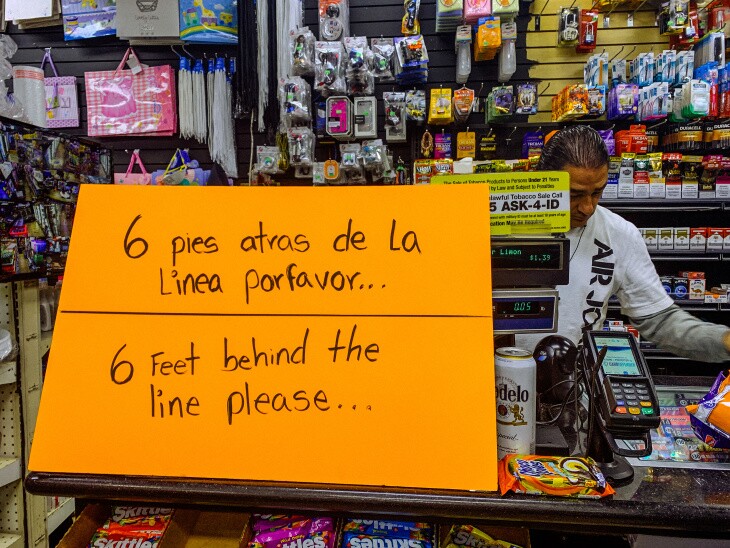 A sign at a local corner store in Boyle Heights asks that people stay 6 feet apart. | Chava Sanchez/LAist
