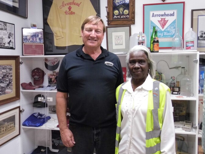 "Mrs. G" (right) in front of a collection of artifacts from Arrowhead's past