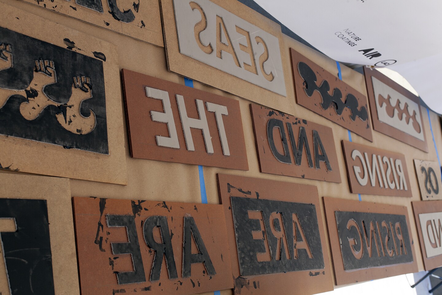 Stencils and stamps hang at a tent during the CicLAvia event at MacArthur Park in 2019. Created by Air artist Elana Mann, the interactive, eco-art project, titled "Dark Victory," invited participants to make custom prints with their bikes using eco-friendly ink.