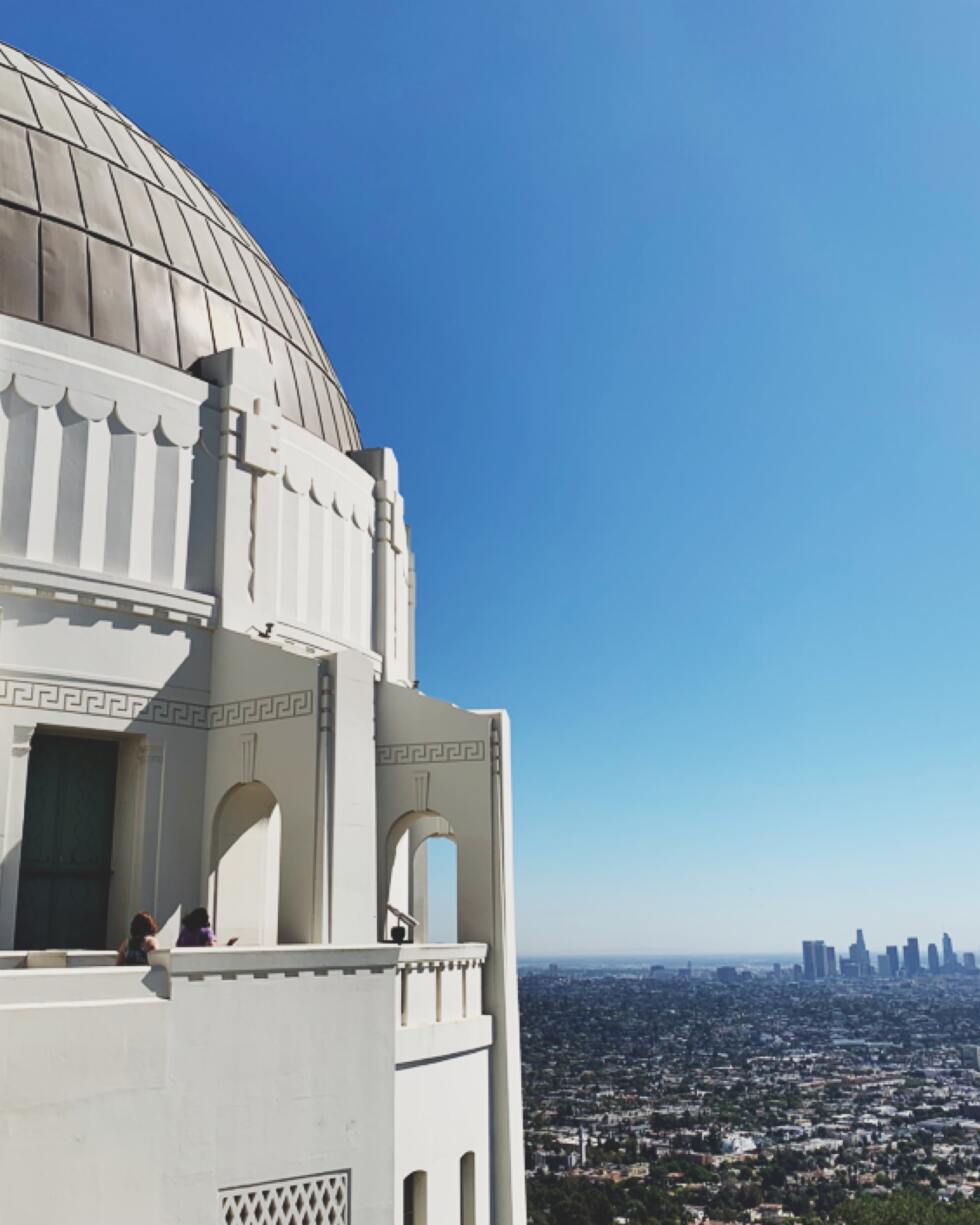A view of a large domed structure overlooking a cityscape.