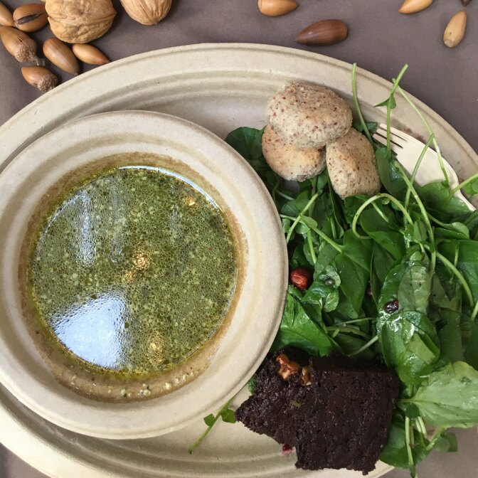 A tasting of a meal at Cafe Ohlone includes acorn flour brownie, a native greens Ohlone salad, bitter greens bisque made with duck fat, and hazelnut flour biscuits. | Momo Chang