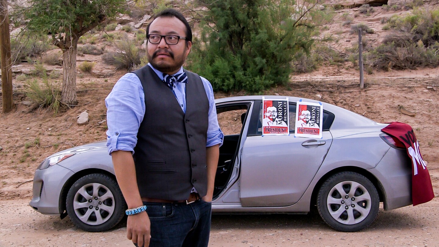 Moroni Benally waits to greet voters arriving at the polling station in Sweetwater, Arizona, on August 26, 2014. | From "America ReFramed: Moroni for President"