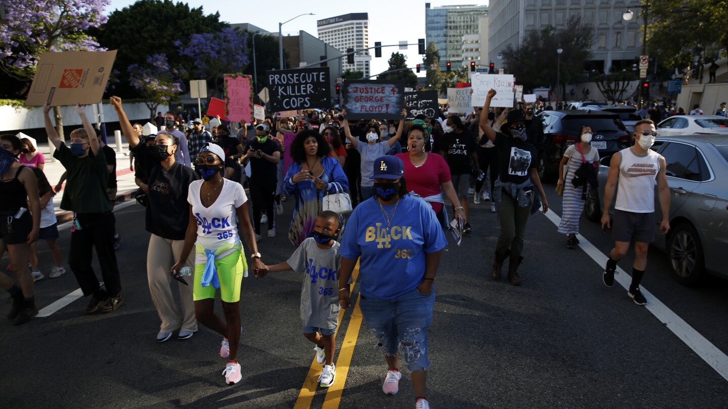 Families take to the streets during a Black Lives Matter protest in downtown Los Angeles. | Dania Maxwell / Los Angeles Times via Getty Images