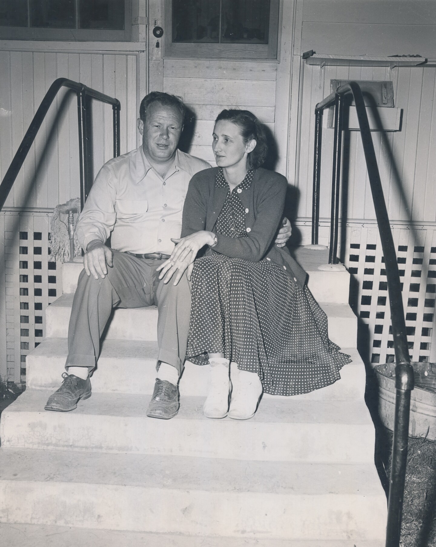 The married couple, Dave and Alice Fiscus, sit together on some steps for a photo.
