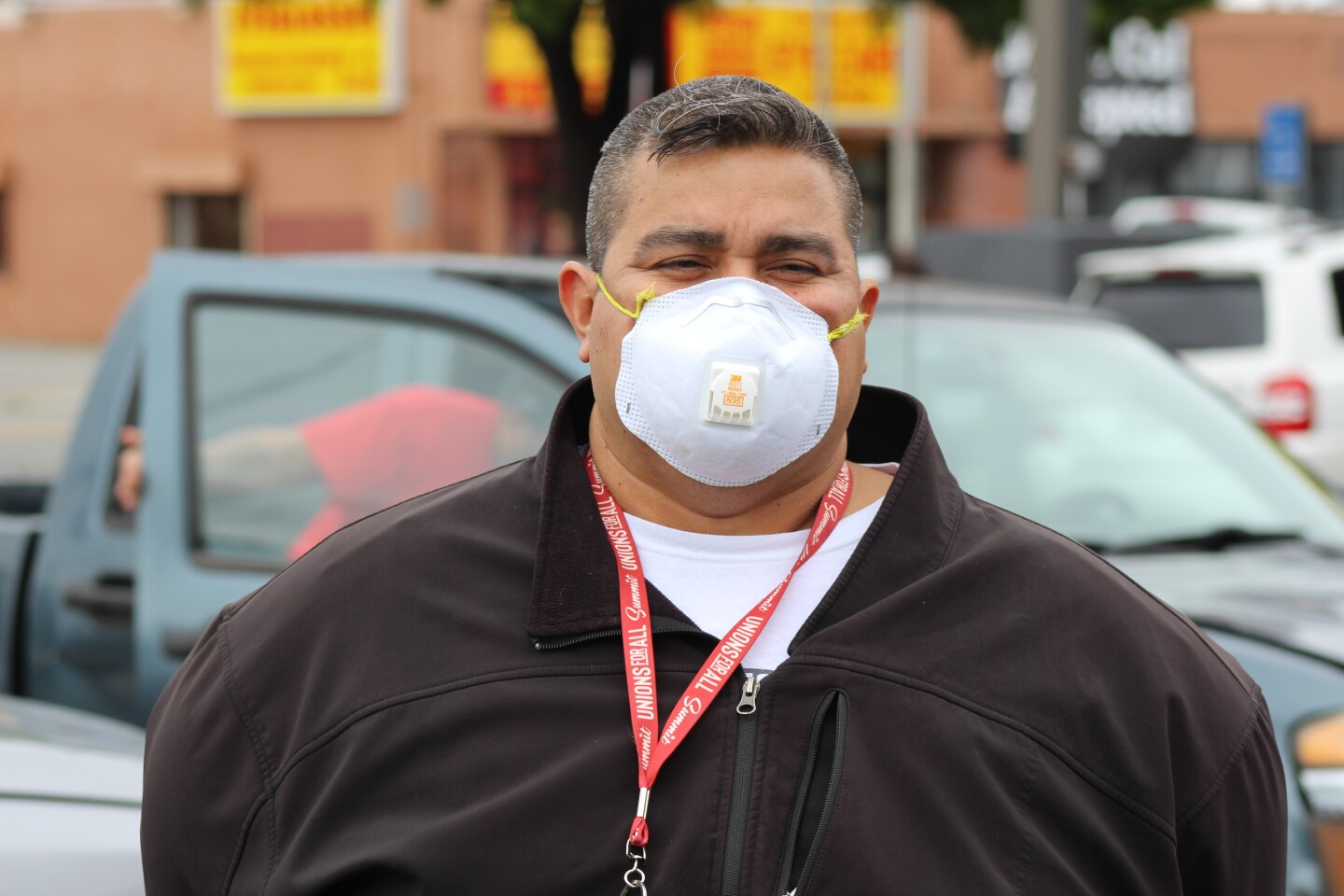 Man wearing a mask wearing a Unions for All lanyard, during protest at McDonalds on April 6, 2020 | Karen Foshay