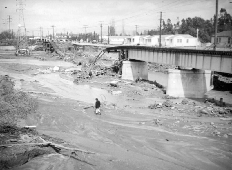 A person walks in the riverbed near a collapsed bridge after the flood of 1938 in North Hollywood