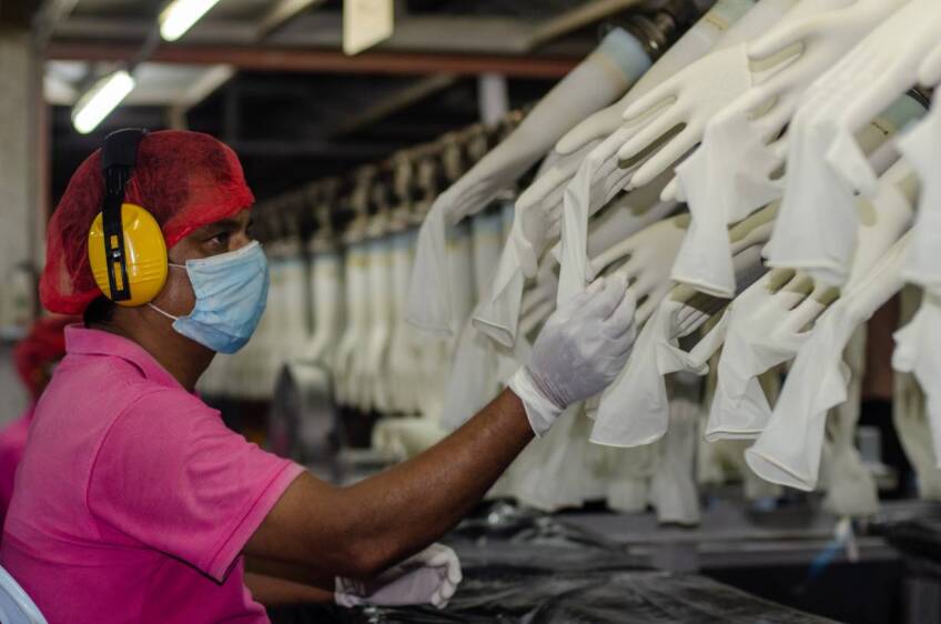 A worker makes checks at the Miditech Gloves' rubber glove factory in Malaysia in 2020. | Miditech Gloves via Thomson Reuters Foundation