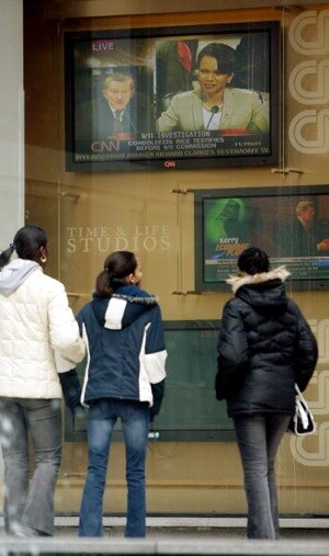 People watch a live broadcast of U.S. National Security Adviser Condoleezza Rice testifying to the National Commission on Terrorist Attacks on the United States April 8, 2004 in New York City. (Photo by Mario Tama/Getty Images)