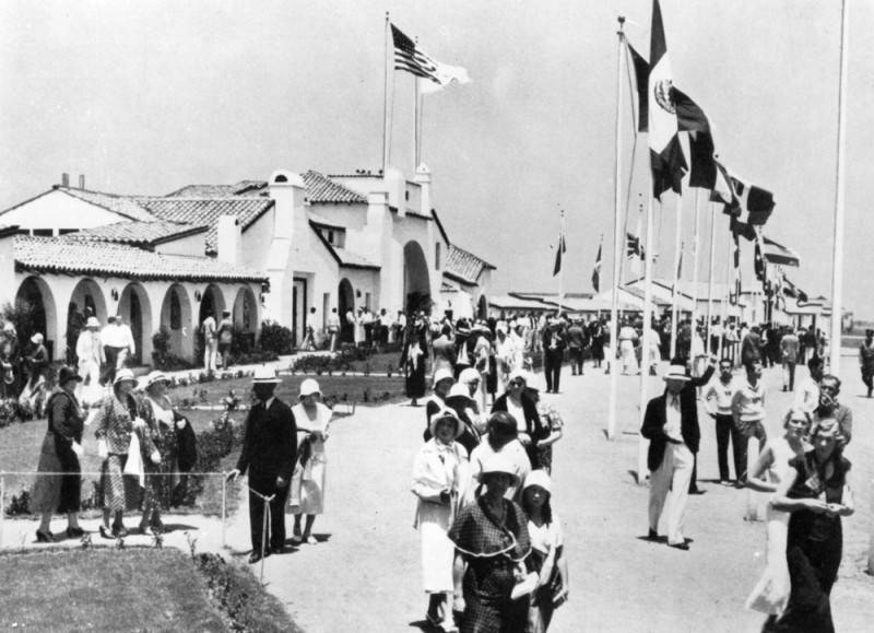 Men and women gather underneath flags at the 1932 Olympics in Los Angeles.