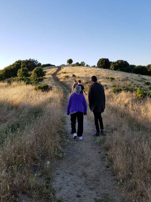 Louis Trevino walking on a trail with an elder during a nature walk. | Courtesy of Vincent Medina