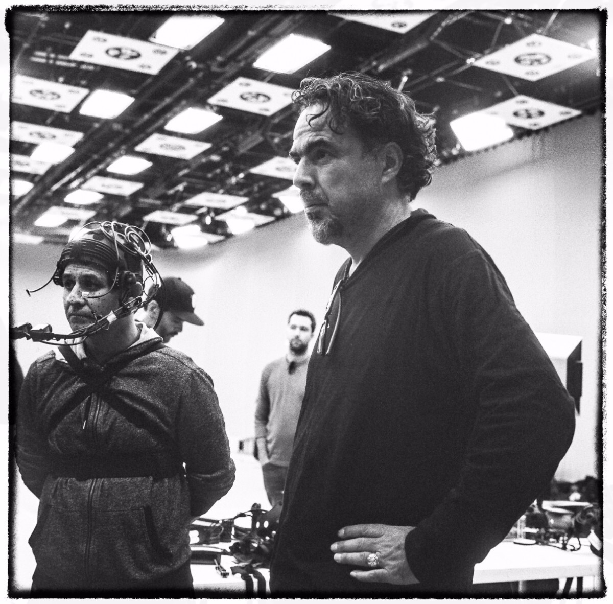 – Alejandro G. Iñárritu directing a baker from El Salvador named Yoni. Yoni is dressed in a motion-capture suit and recreating a harrowing moment on his journey. Photo credit: Chachi Ramirez.