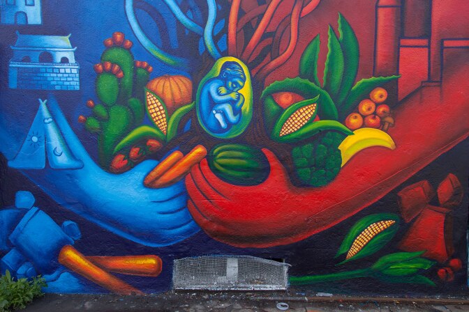 “blue and red sky with baby (Avalon Alley Murals, 2016)” by Noni Olabisi.