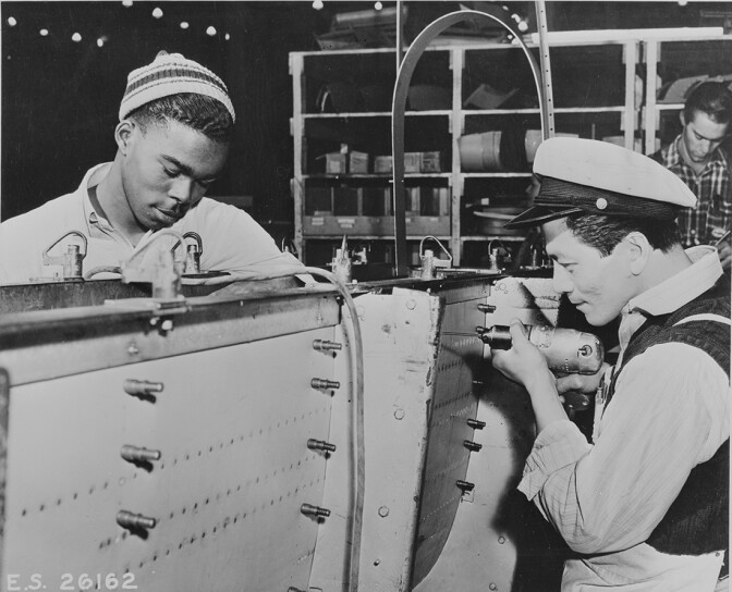 Douglas Aircraft Company's El Segundo plant workers Richard Springfield and William Ung constructing a plane together, between 1935 and 1945. | Library of Congress