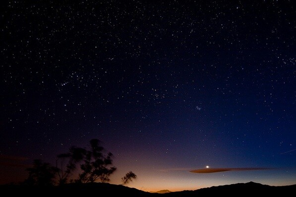The sky over Joshua Tree transitions from sunset to night sky