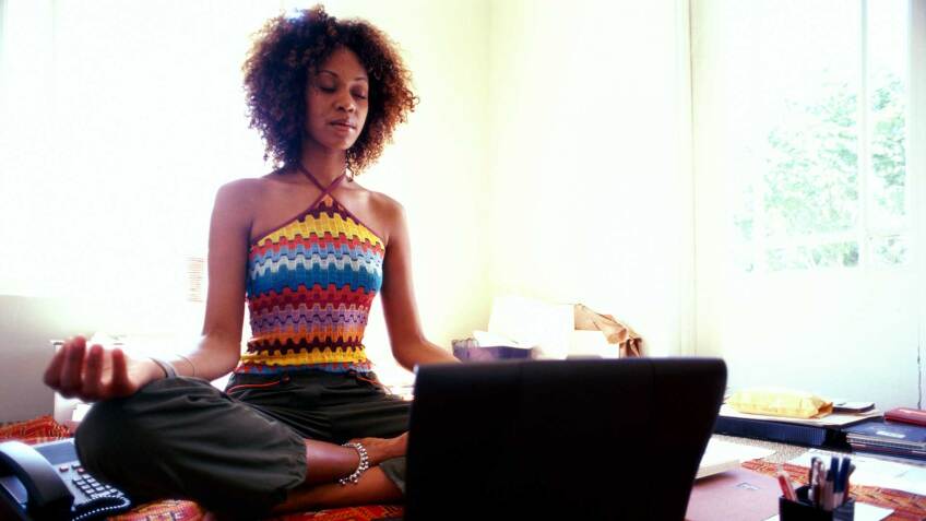 woman meditates on her rug, royalty free on Getty