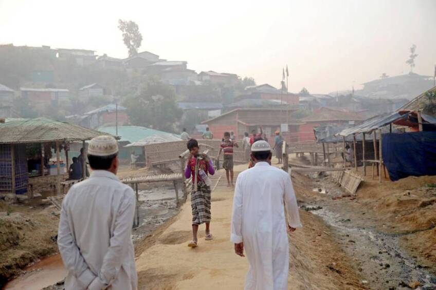 FILE PHOTO: Rohingya refugees walk on a road at the Balukhali camp in Cox's Bazar, Bangladesh, April 8, 2019. | REUTERS/Mohammad Ponir Hossain/File Photo