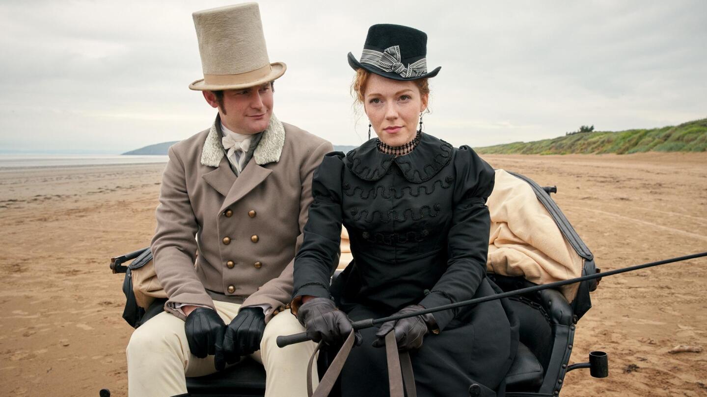 A man and woman sit in a carriage in the middle of a sandy landscape. | "Sanditon on Masterpiece: Episode 8"