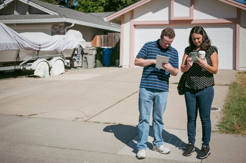 Taylor Kayatta (left) and parent-teacher Vanessa Cudabac (right) during a door-to-door campaign strategy on Aug. 13, 2022.