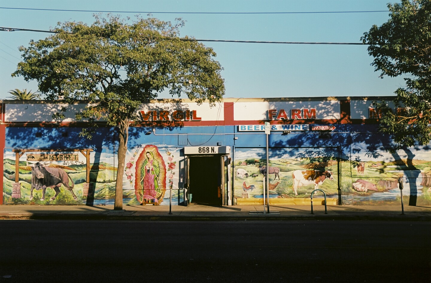 A mural of a farm and Virgen de Guadalupe on the walls of Virgil Farm Market in East Hollywood.