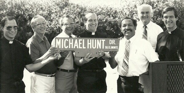 Father Joe with Michael Hunt Drive street sign | Courtesy of South El Monte Arts Posse/South El Monte City Hall