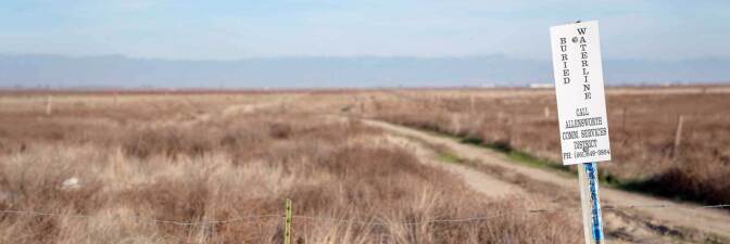 Sign indicating buried water line from a new well to serve Allensworth. (narrow) | Carla Pineda