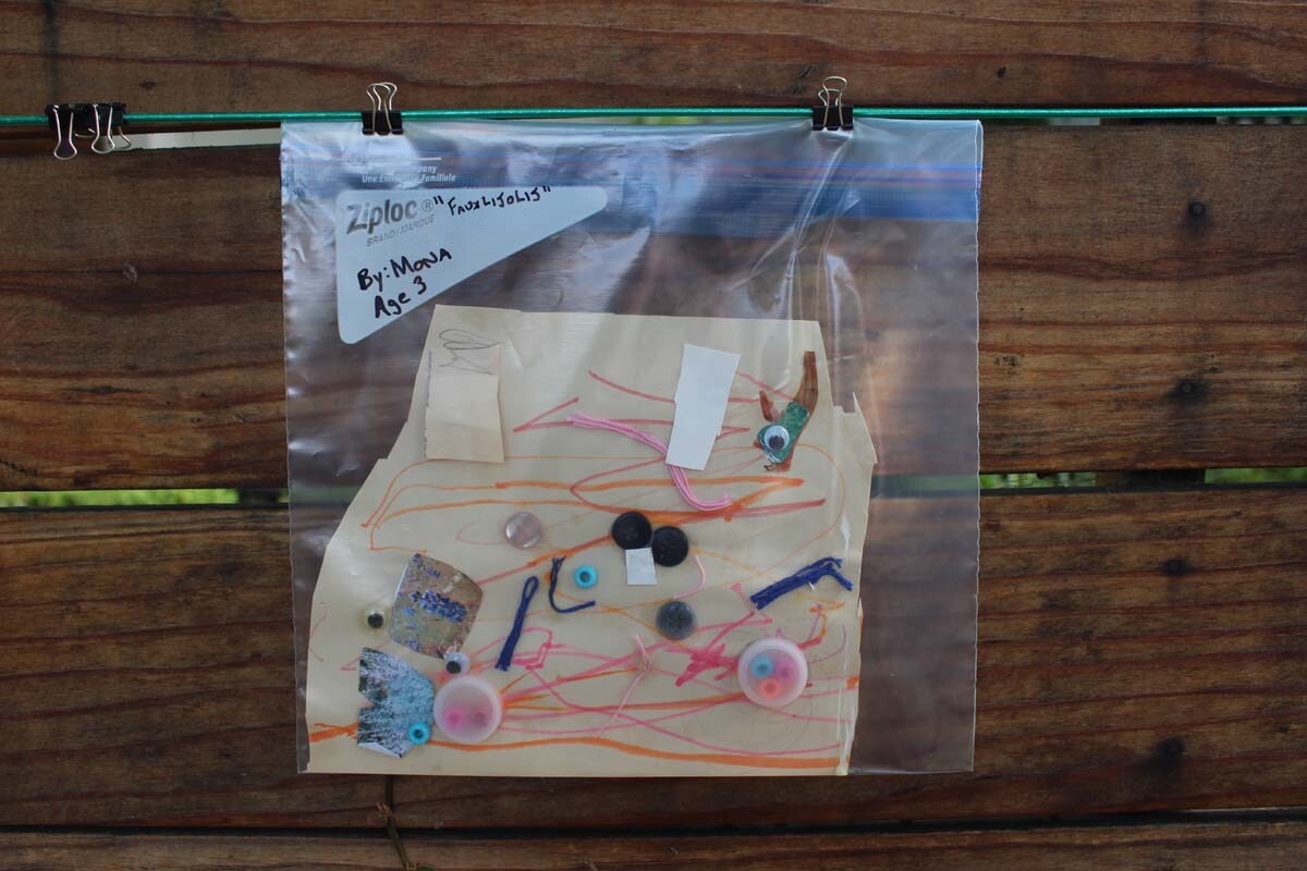 "Fauxlijolij" a piece made of found objects resembling fish by child artist Mona hangs on Dan Fields’ Los Feliz fence gallery.