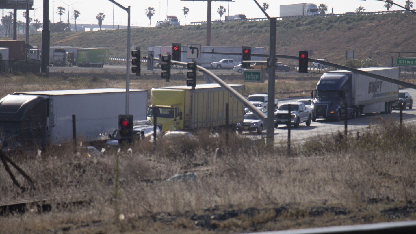 Diesel trucks passing through Van Buren Boulevard and Etiwanda Avenue in Mira Loma.