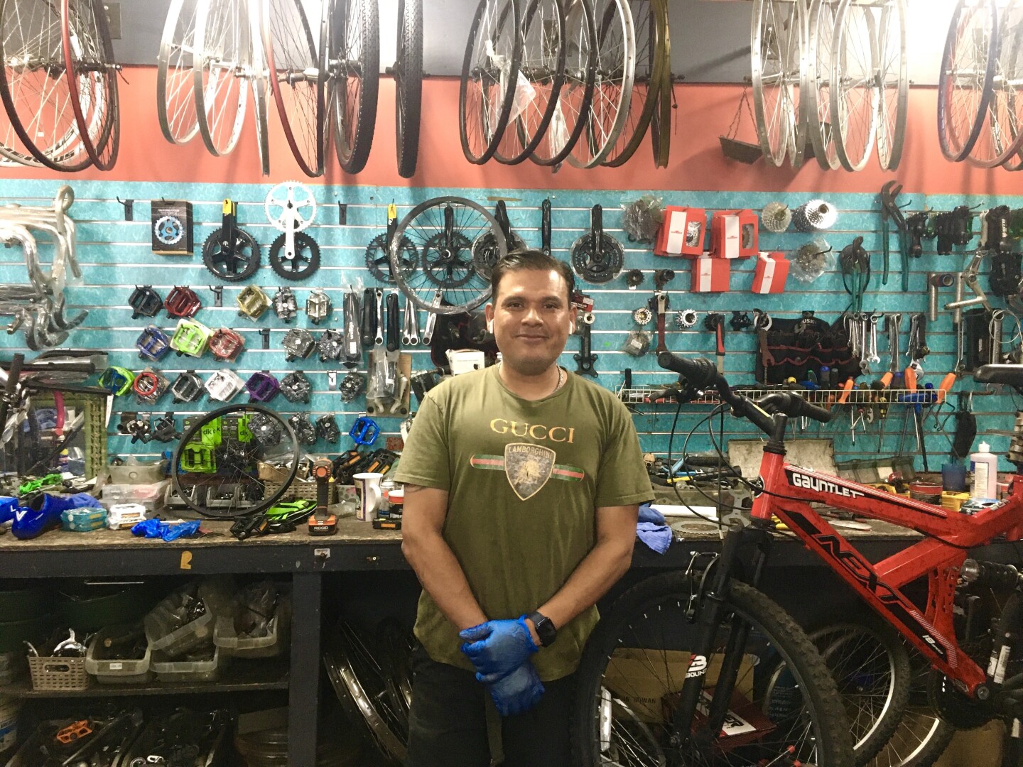 Nestor Lobo, owner of Retro Xpress Bicycles in Van Nuys, stands in front of his work station.