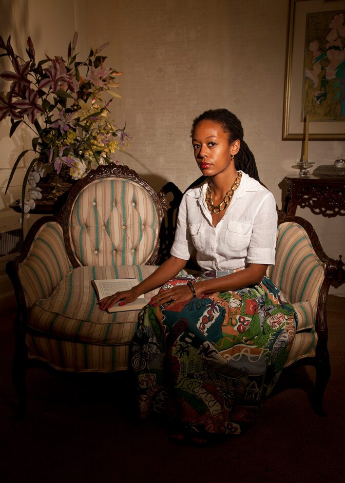 Jana Ireland "The Love Seat," 2014 features a woman in a white blouse and green skirt sitting on a loveseat. Injet print, 36 x 24 in. | Courtesy the artist