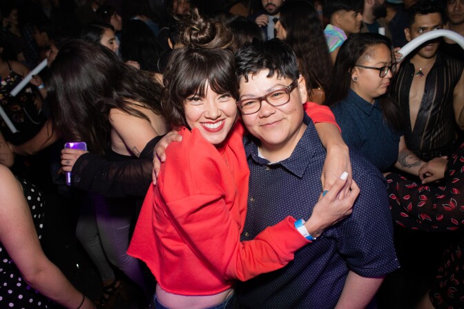 Two people hug at the Cumbiatón party.