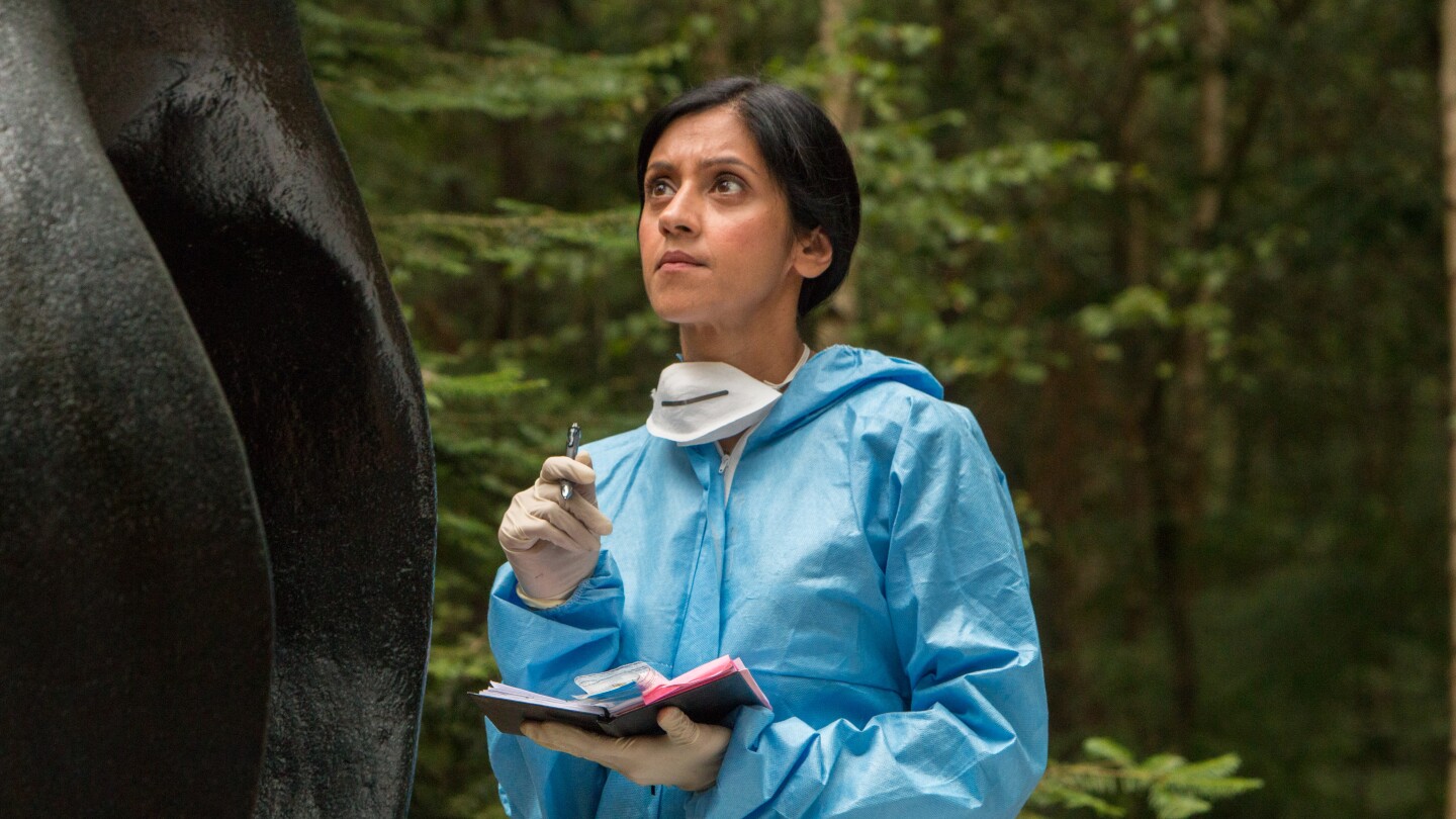 A woman looks at a statue.