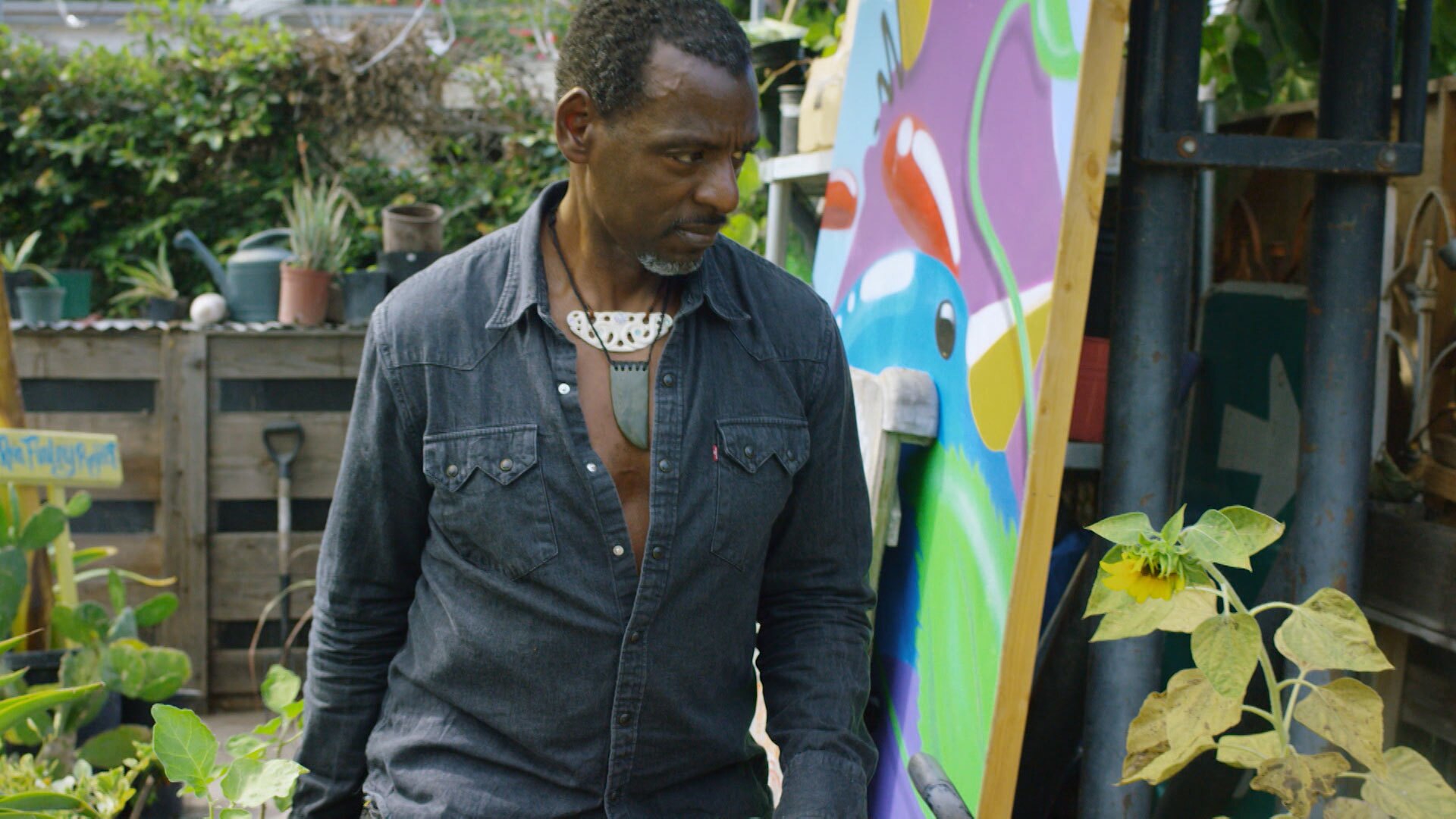 Ron Finley walks through his garden. | Still from "Broken Bread"