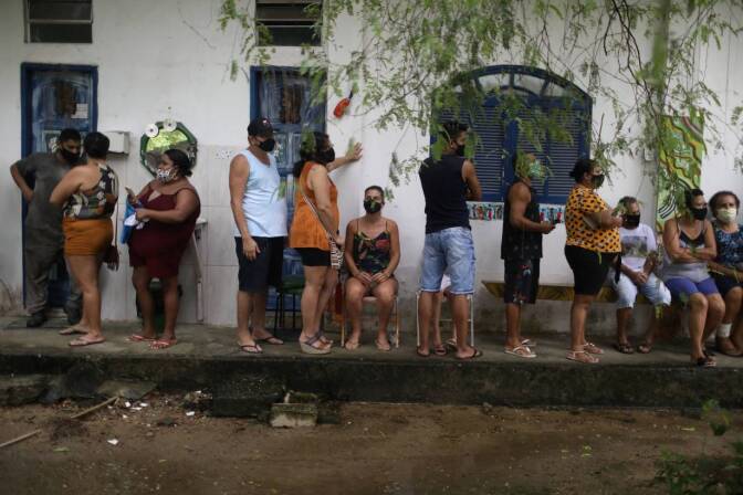 Residents wait in line to receive the Sinovac's CoronaVac coronavirus disease (COVID-19) vaccine at the community Quilombo Quilomba, descendants of African slaves, in Mage, Rio de Janeiro state, Brazil April 7, 2021.