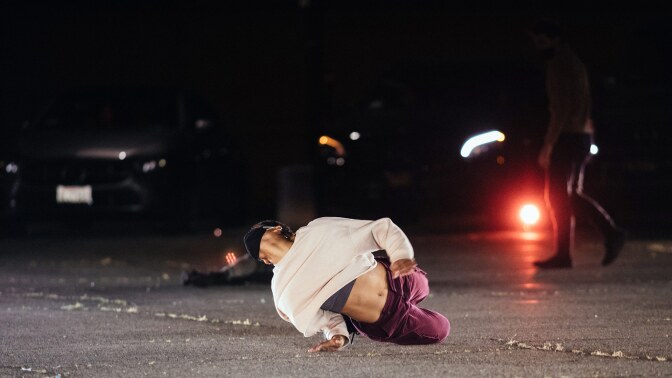 A dancer contorts on the ground in "Parked." | Matthew Brush