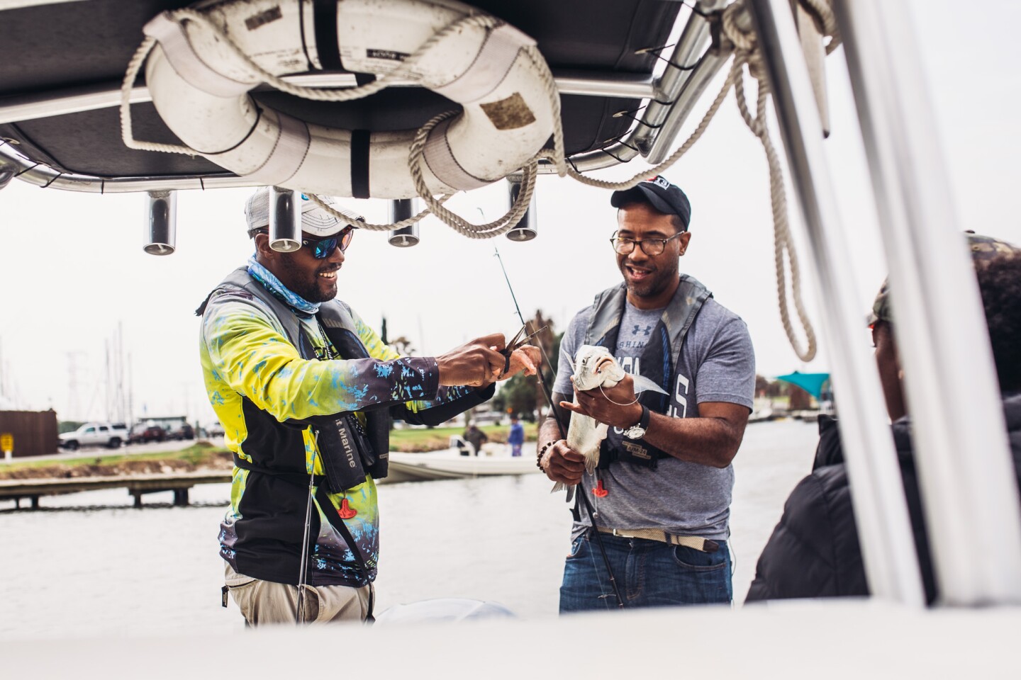 Captain Fred fishes alongside Chef Chris Williams Black Drum fish.