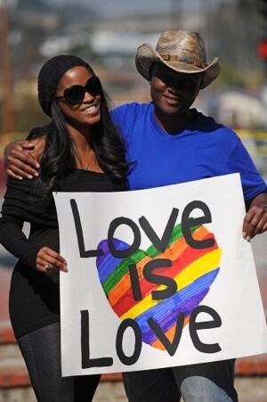 A lesbian couple hold a sign at a protest outside the County ClerkÂ’s Office in Los Angeles on Valentine's Day | AFP/Getty Images